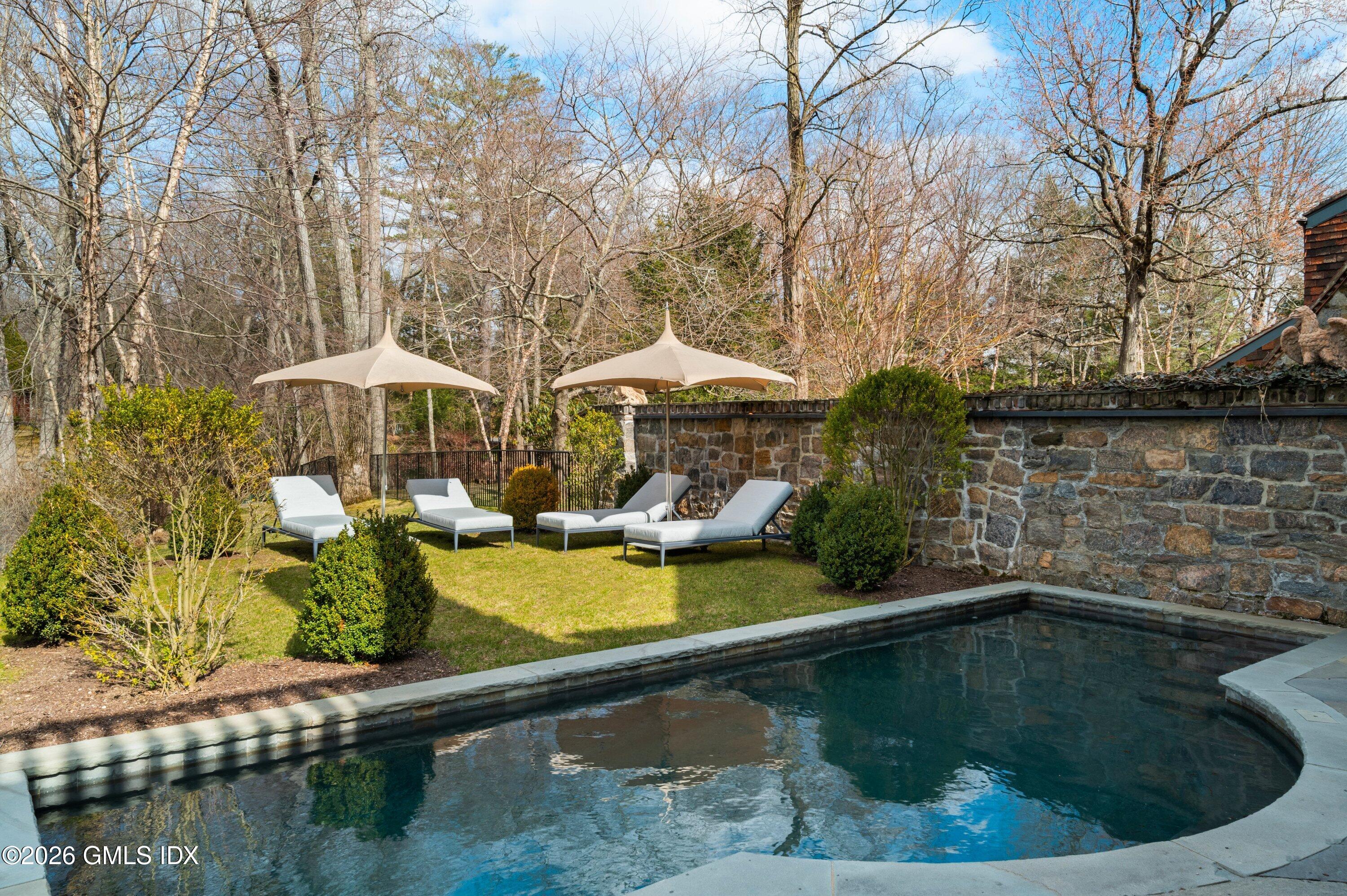 44 Khakum Wood Road Greenwich, CT 06831 - Photo 7 of 7 a swimming pool with outdoor seating and yard