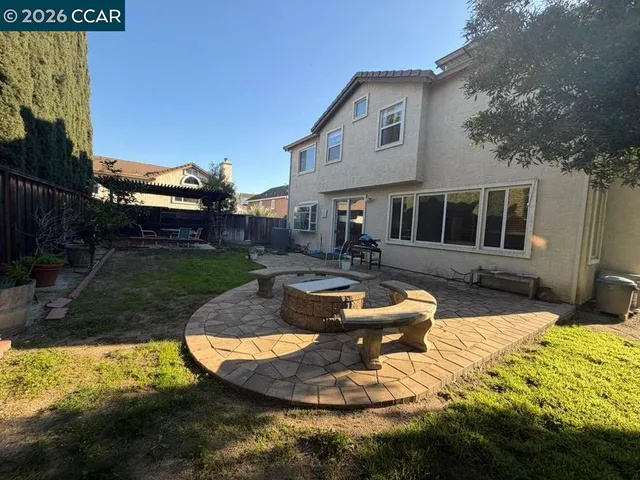 a view of a house with a yard and a garage
