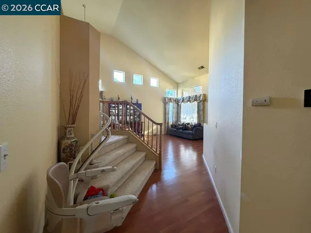 a view of a livingroom with furniture and hardwood floor