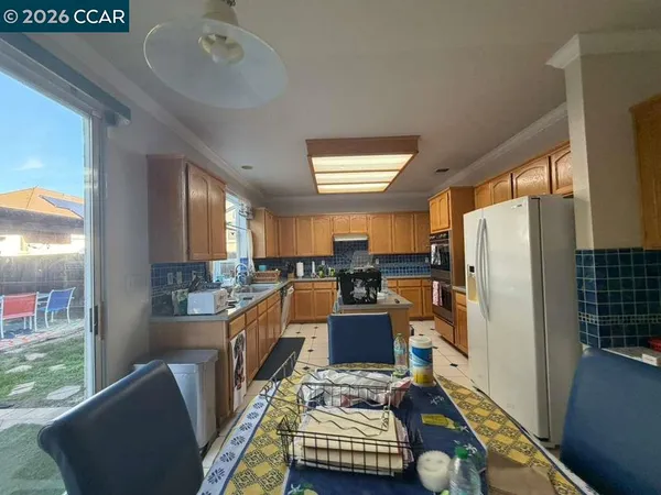 a dining room with furniture and a window