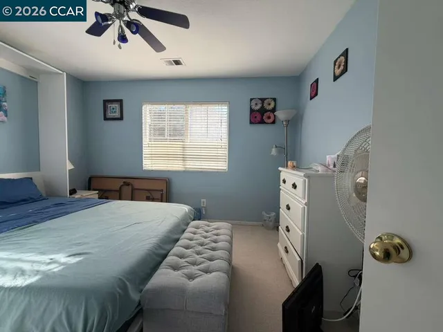 a living room with furniture and stairs