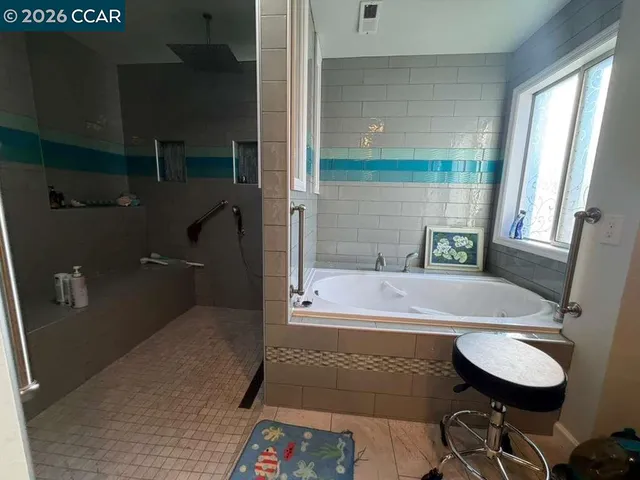 a view of a hallway with wooden floor and a living room