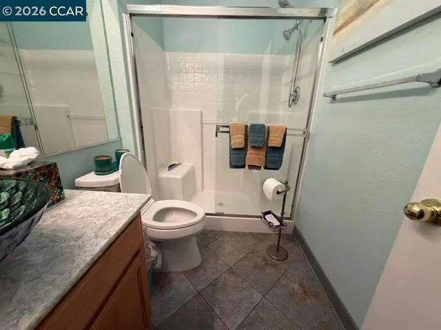 a view of a hallway with wooden floor and stairs