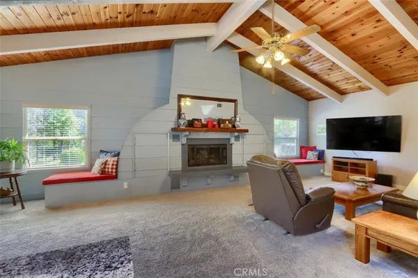 a dining hall with stainless steel appliances kitchen island granite countertop furniture wooden floor and a view of kitchen