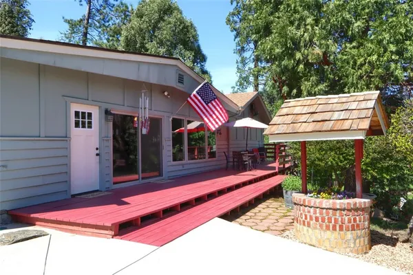 a living room with furniture a table and chairs next to a window