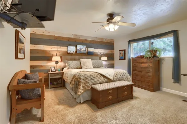 a bedroom with a bed window and couch