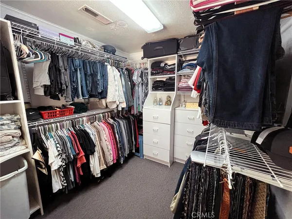 a bedroom with furniture and mirror