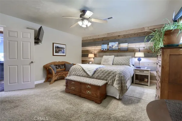 a bedroom with bed and a chandelier