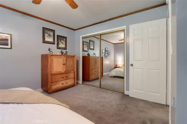 a bedroom with a bed and flat screen tv