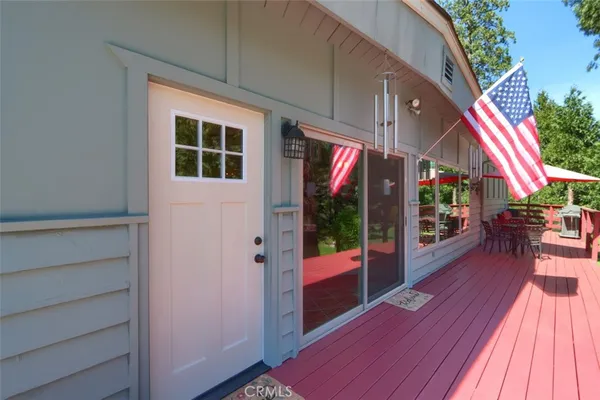 a living room with furniture a flat screen tv and a table