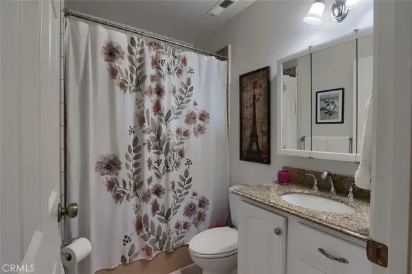 a storage room with wooden floor washer and dryer