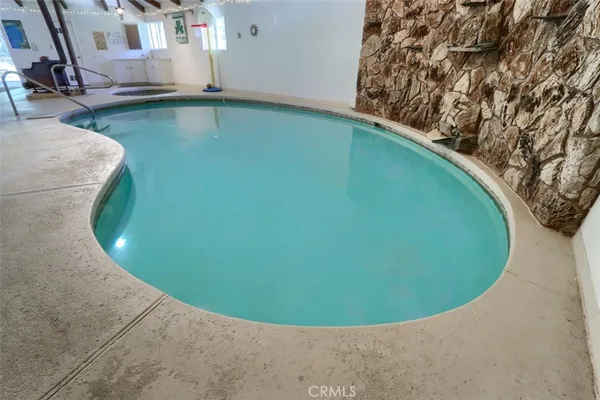 a view of a house with backyard and a tree