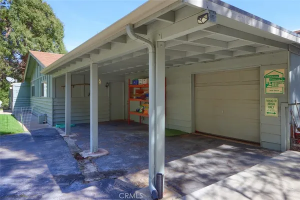 an aerial view of a house with a yard and a large tree