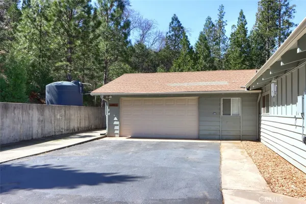 an aerial view of a house with a yard and outdoor seating