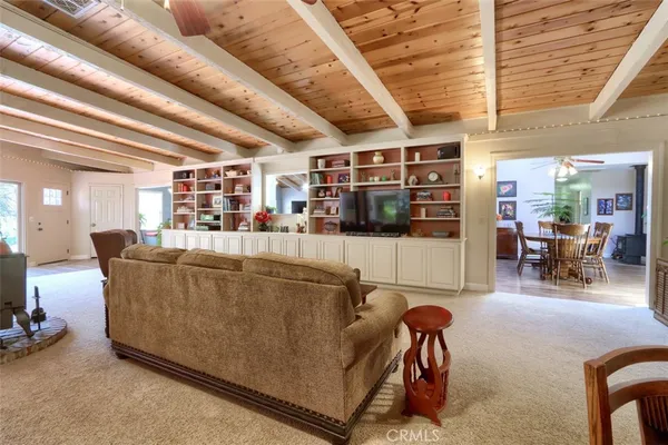 a living room with furniture a rug and a large window