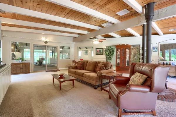 a dining room with furniture a chandelier and wooden floor