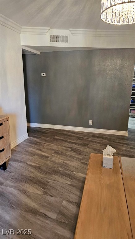 3151 North Soaring Gulls Drive, Unit 2211 Las Vegas, NV 89128 - Photo 8 of 20 Empty room featuring dark wood-type flooring and crown molding