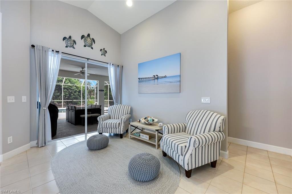 697 Crossfield Circle Naples, FL 34104 - Photo 3 of 18 Sitting room with tile patterned flooring, ceiling fan, and high vaulted ceiling