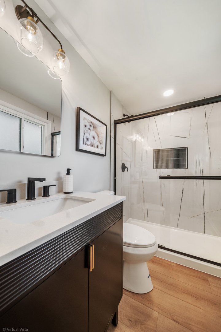 21-w040 Monticello Road Lombard, IL 60148 - Photo 15 of 33 a bathroom with a sink a toilet and shower