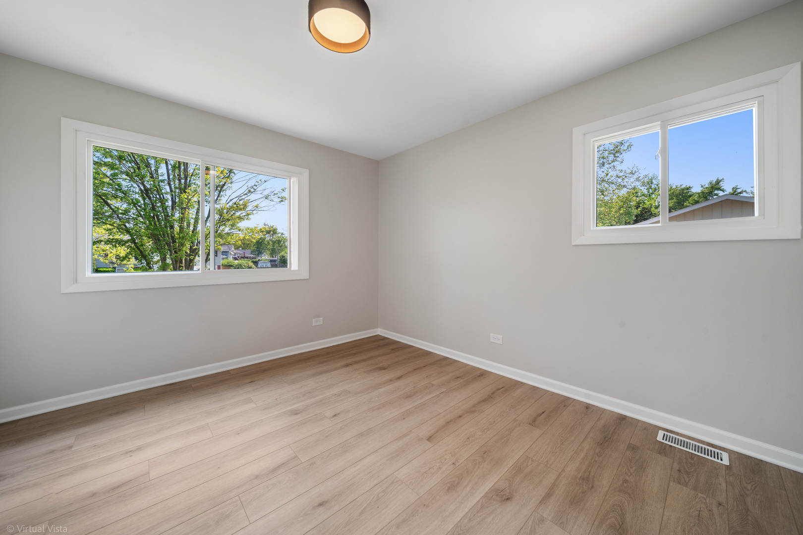 21-w040 Monticello Road Lombard, IL 60148 - Photo 16 of 33 a view of an empty room with wooden floor and window