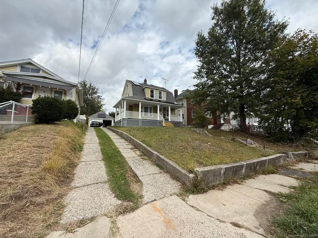 a view of yard with swimming pool and seating area