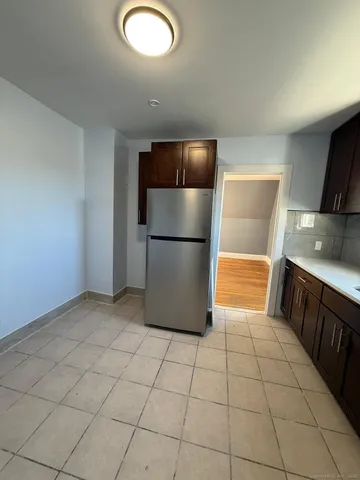 a kitchen with stainless steel appliances a refrigerator sink and microwave