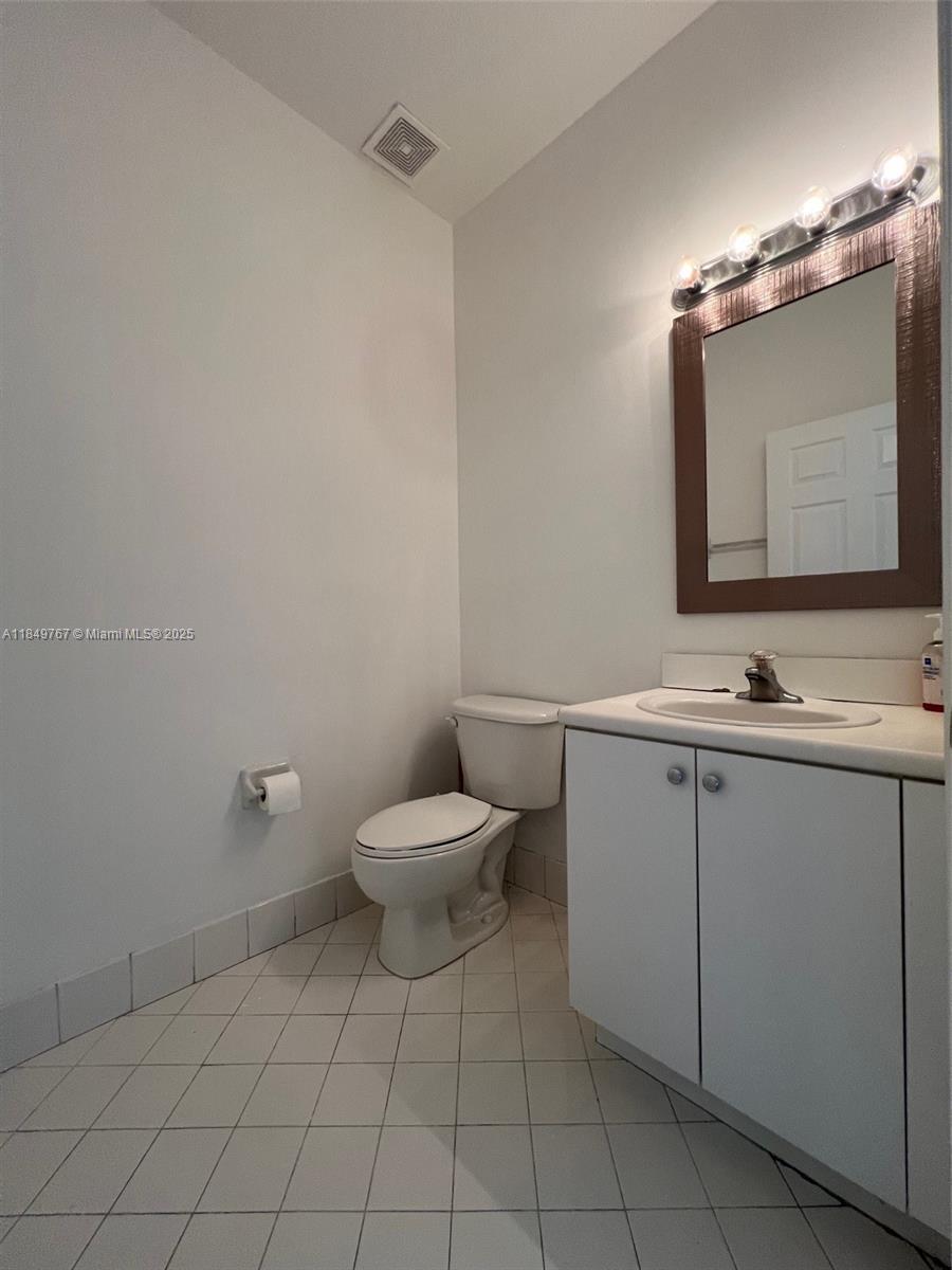 12724 Southwest 133rd Street Miami, FL 33186 - Photo 11 of 33 a bathroom with a toilet sink and mirror