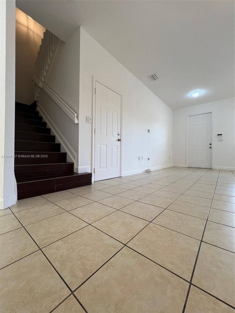12724 Southwest 133rd Street Miami, FL 33186 - Photo 13 of 33 a view of an empty room with stairs