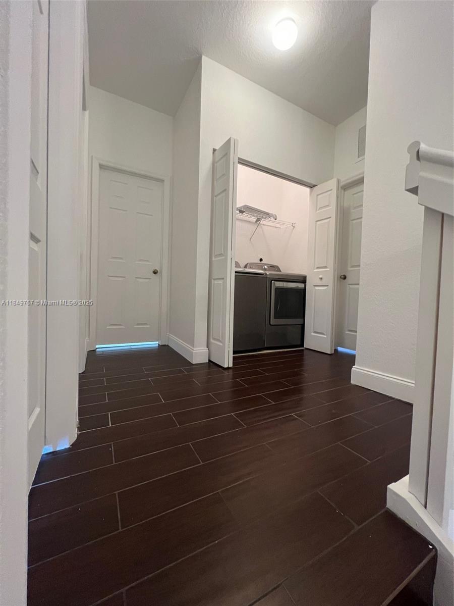 12724 Southwest 133rd Street Miami, FL 33186 - Photo 14 of 33 a view of an empty room with wooden floor and a fire place