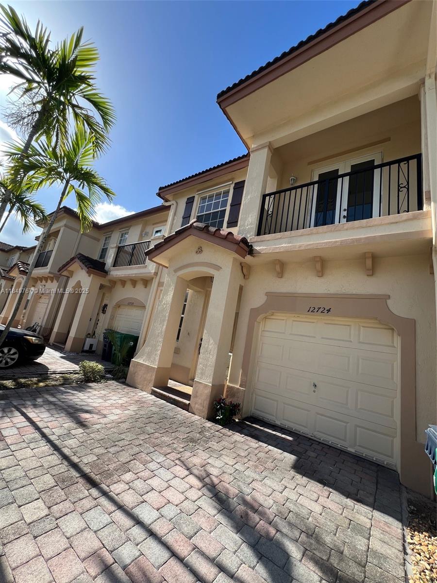12724 Southwest 133rd Street Miami, FL 33186 - Photo 2 of 33 a front view of a house with a yard
