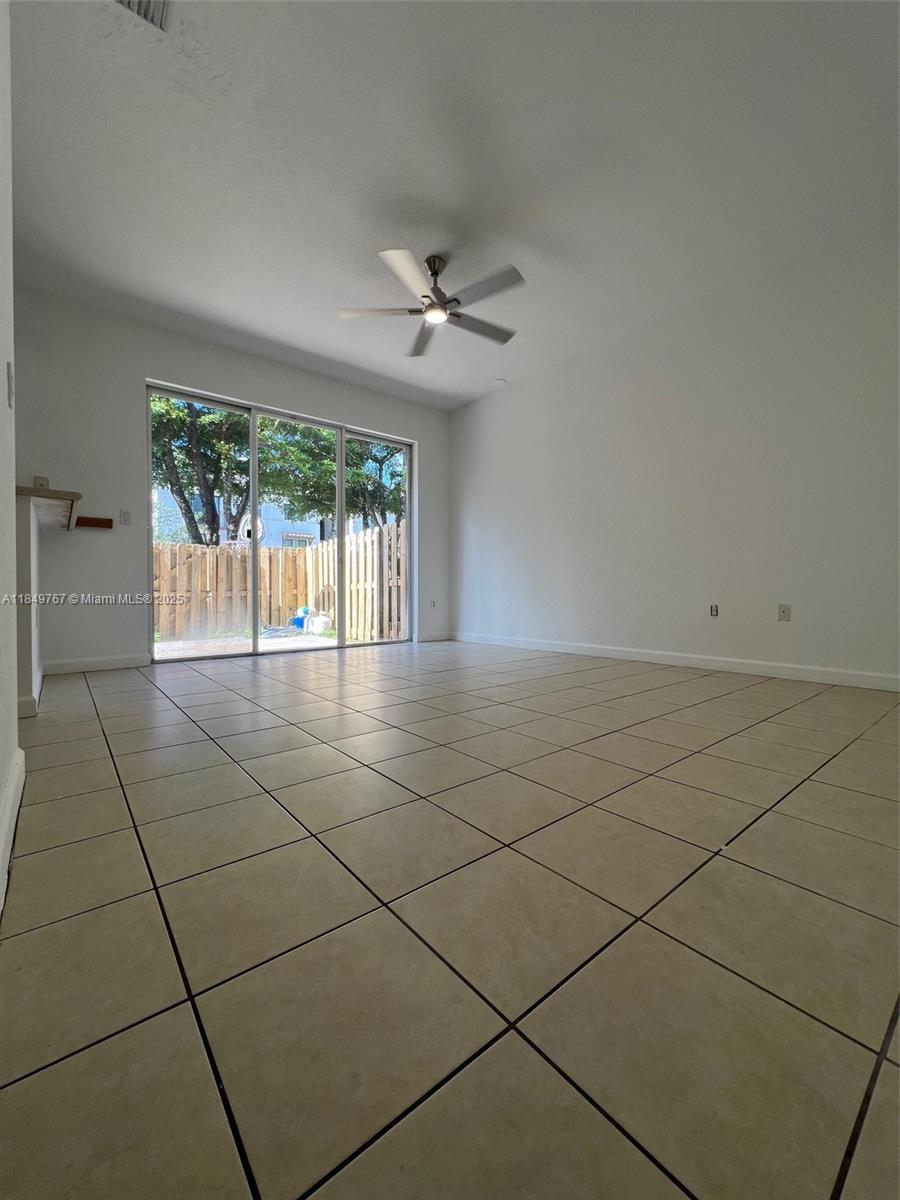 12724 Southwest 133rd Street Miami, FL 33186 - Photo 9 of 33 an empty room with windows and ceiling fan