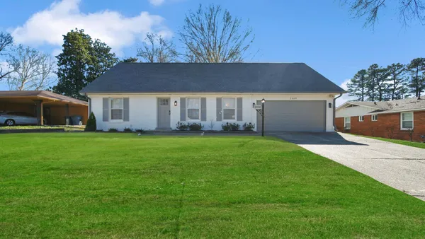 a front view of house with yard and green space