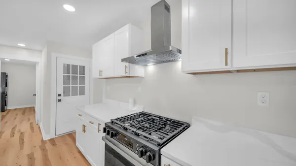 a kitchen with stainless steel appliances a stove and cabinets