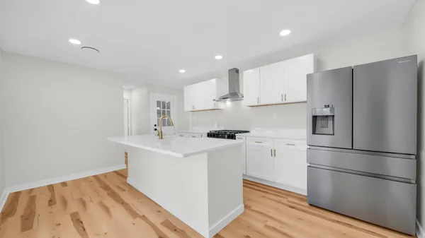 a kitchen with stainless steel appliances a refrigerator sink and microwave
