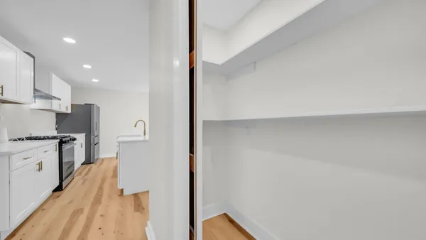 a kitchen with stainless steel appliances a refrigerator and a stove top oven