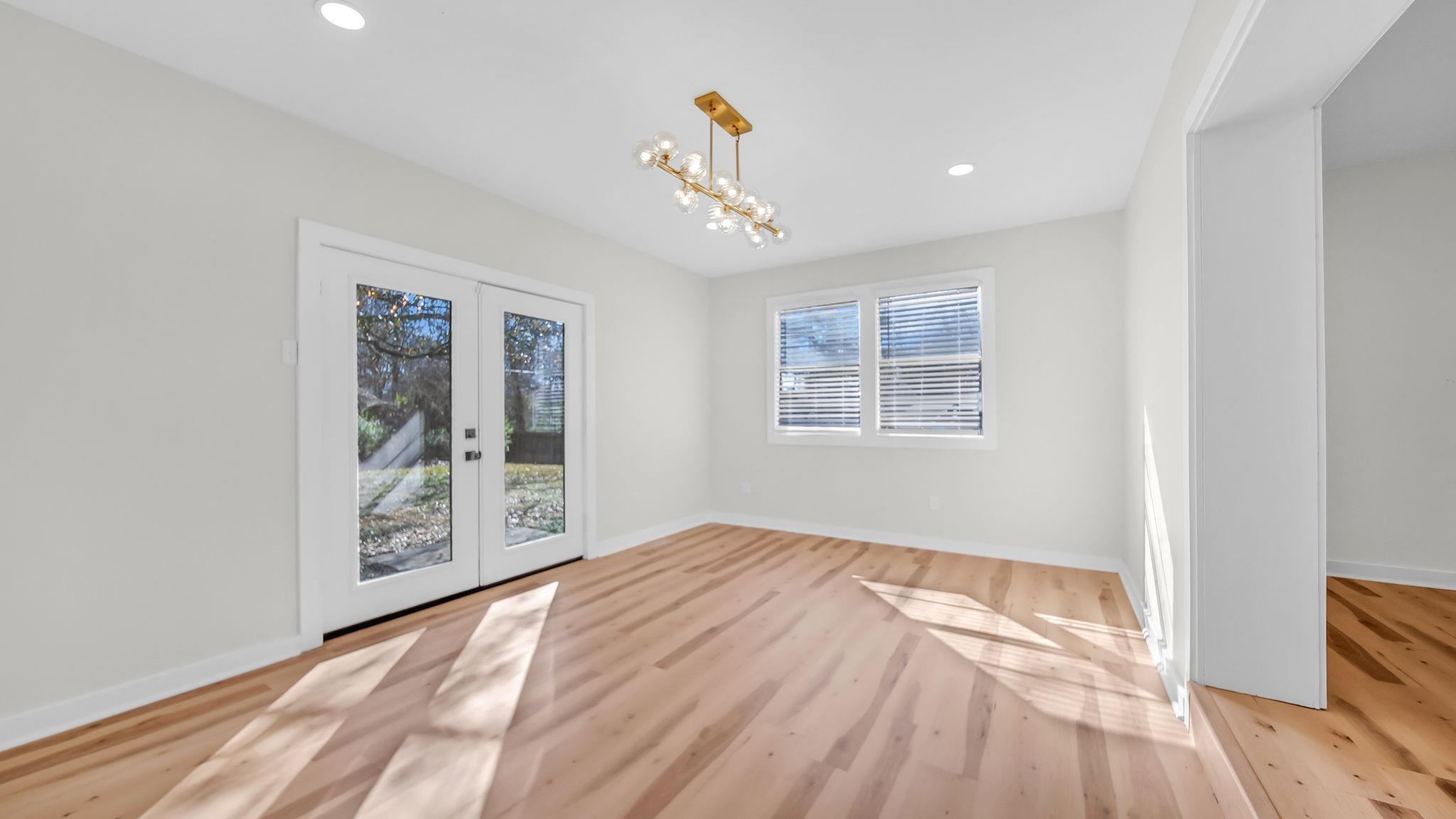2800 Spring Hill Drive Memphis, TN 38127 - Photo 18 of 31 Unfurnished dining area with french doors, light wood-type flooring, recessed lighting, and a chandelier