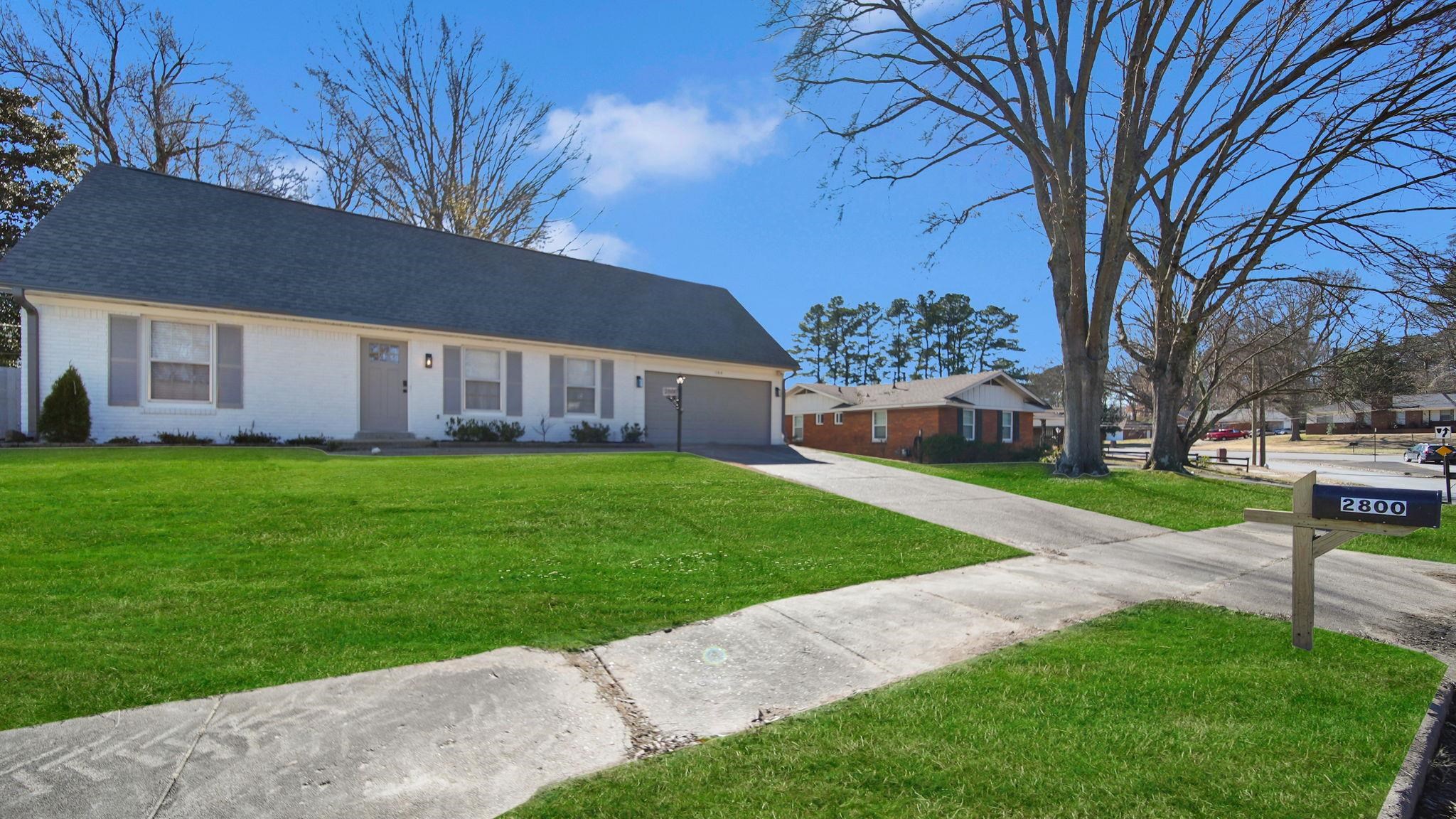 2800 Spring Hill Drive Memphis, TN 38127 - Photo 2 of 31 Ranch-style home featuring brick siding, driveway, a front lawn, and a garage