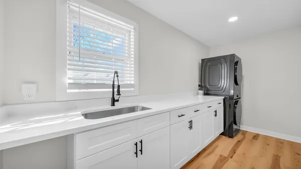a kitchen with granite countertop white cabinets and sink