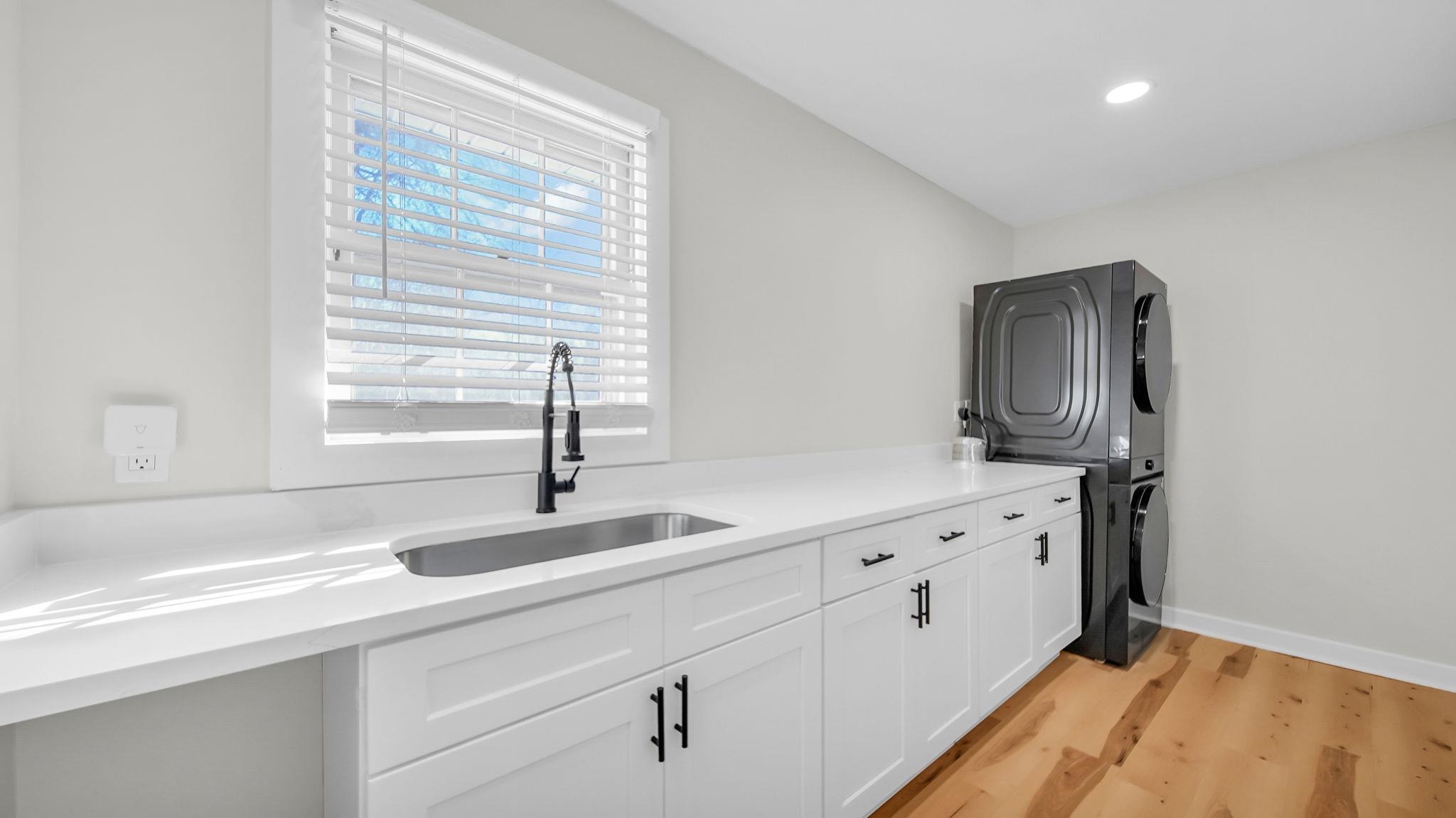 2800 Spring Hill Drive Memphis, TN 38127 - Photo 21 of 31 Washroom with stacked washer / dryer, light wood finished floors, cabinet space, and recessed lighting