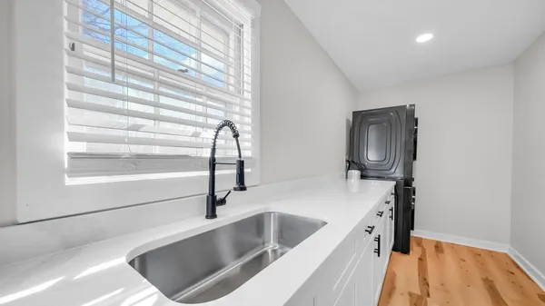 a kitchen with a sink cabinets and appliances