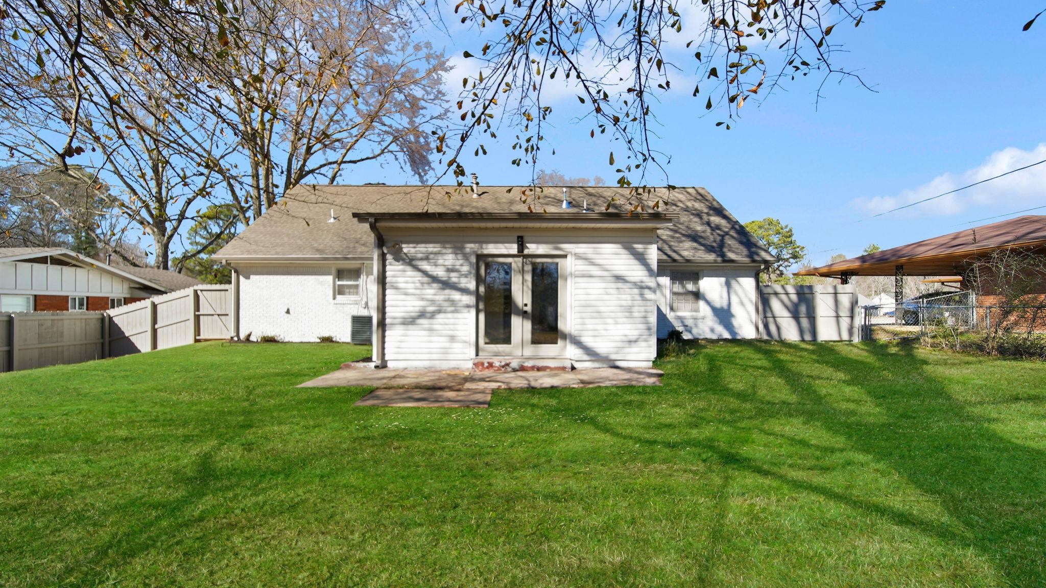 2800 Spring Hill Drive Memphis, TN 38127 - Photo 6 of 31 Rear view of house featuring a fenced backyard, french doors, a patio, brick siding, and roof with shingles