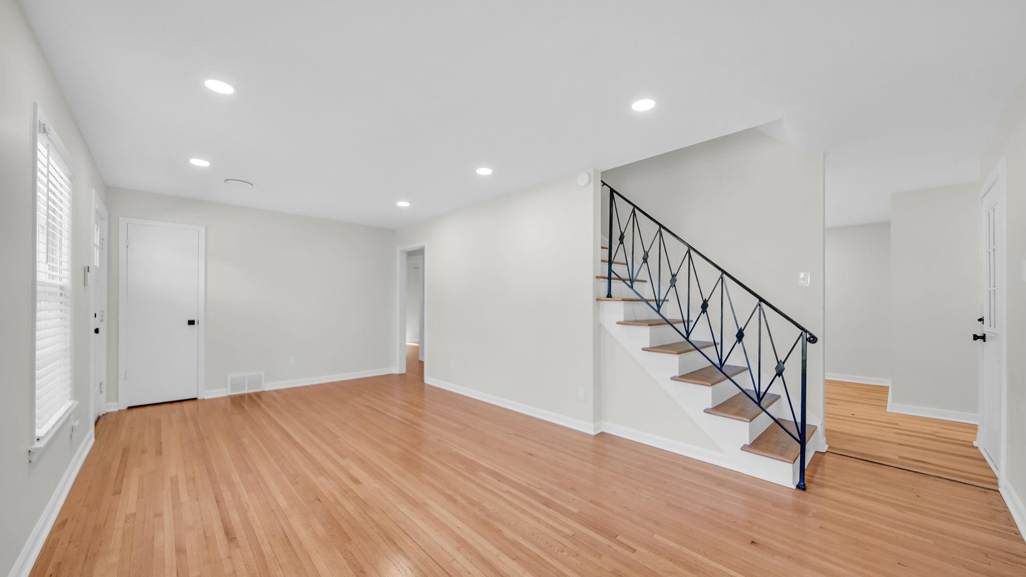 2800 Spring Hill Drive Memphis, TN 38127 - Photo 8 of 31 Unfurnished living room featuring stairs, recessed lighting, and light wood-style floors