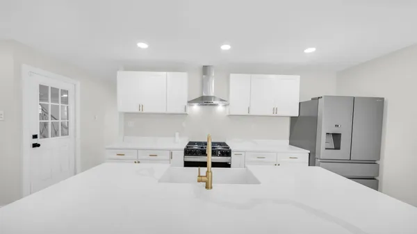 a kitchen with refrigerator and window