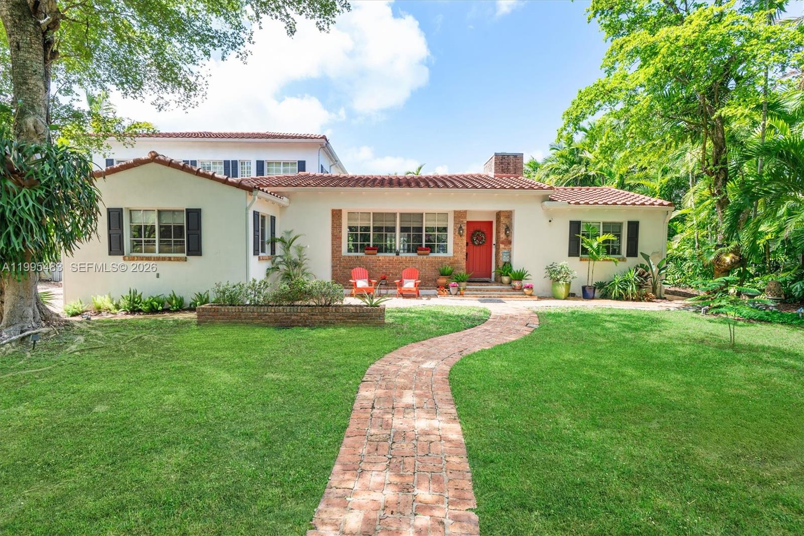9636 Northeast 5th Avenue Road Miami Shores, FL 33138 - Photo 12 of 86 a front view of house with yard and green space