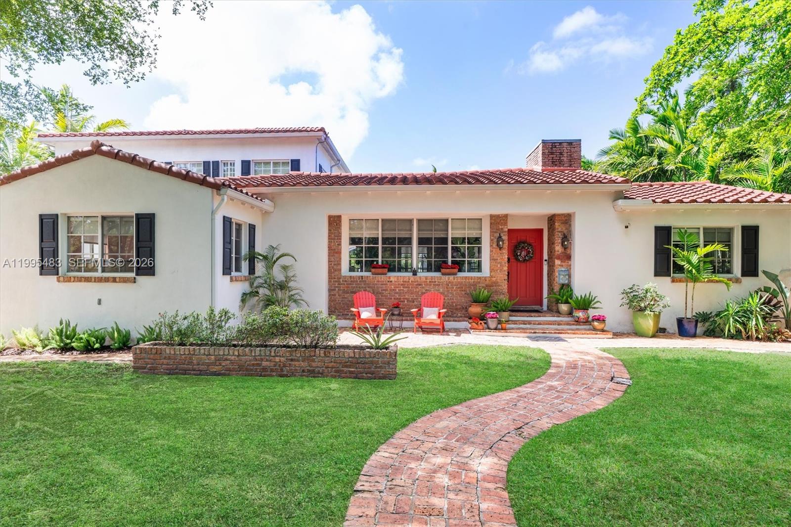 9636 Northeast 5th Avenue Road Miami Shores, FL 33138 - Photo 15 of 86 a front view of a house with a garden and plants