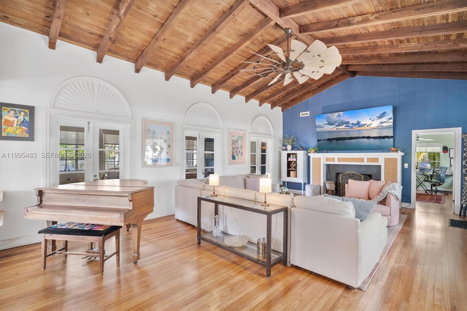 9636 Northeast 5th Avenue Road Miami Shores, FL 33138 - Photo 17 of 86 a living room with furniture a fireplace and a chandelier