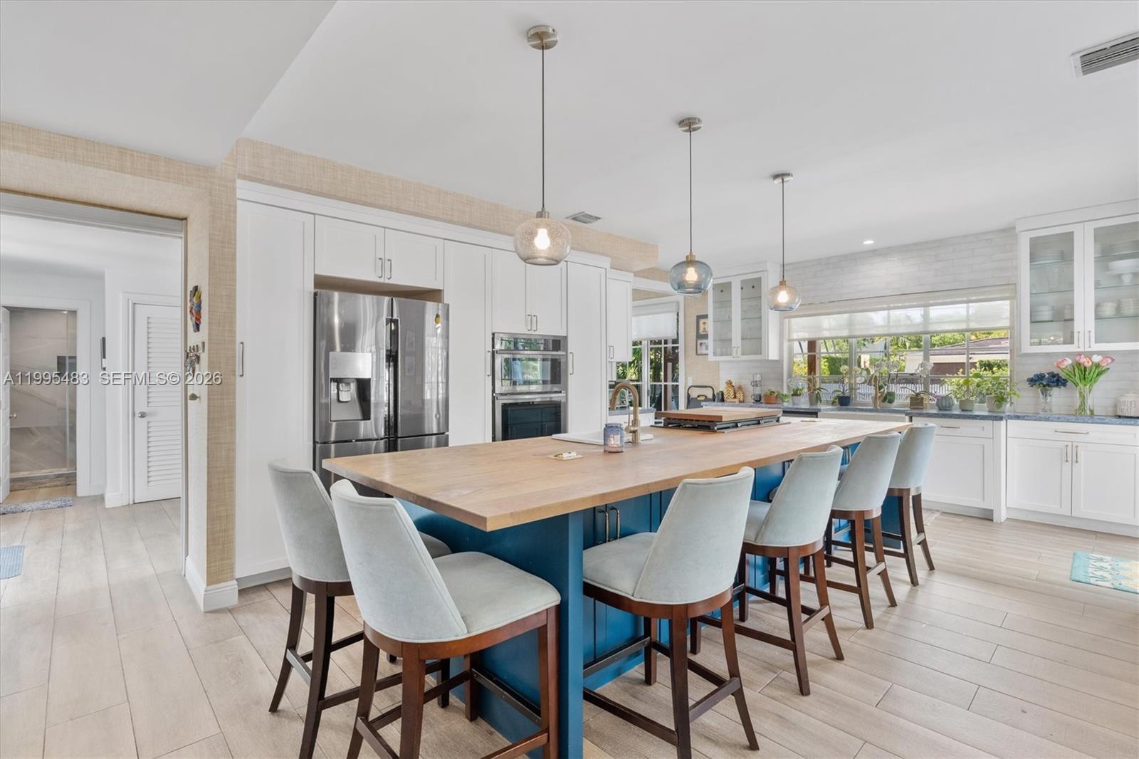 9636 Northeast 5th Avenue Road Miami Shores, FL 33138 - Photo 25 of 86 a dining table with chairs and wooden floor