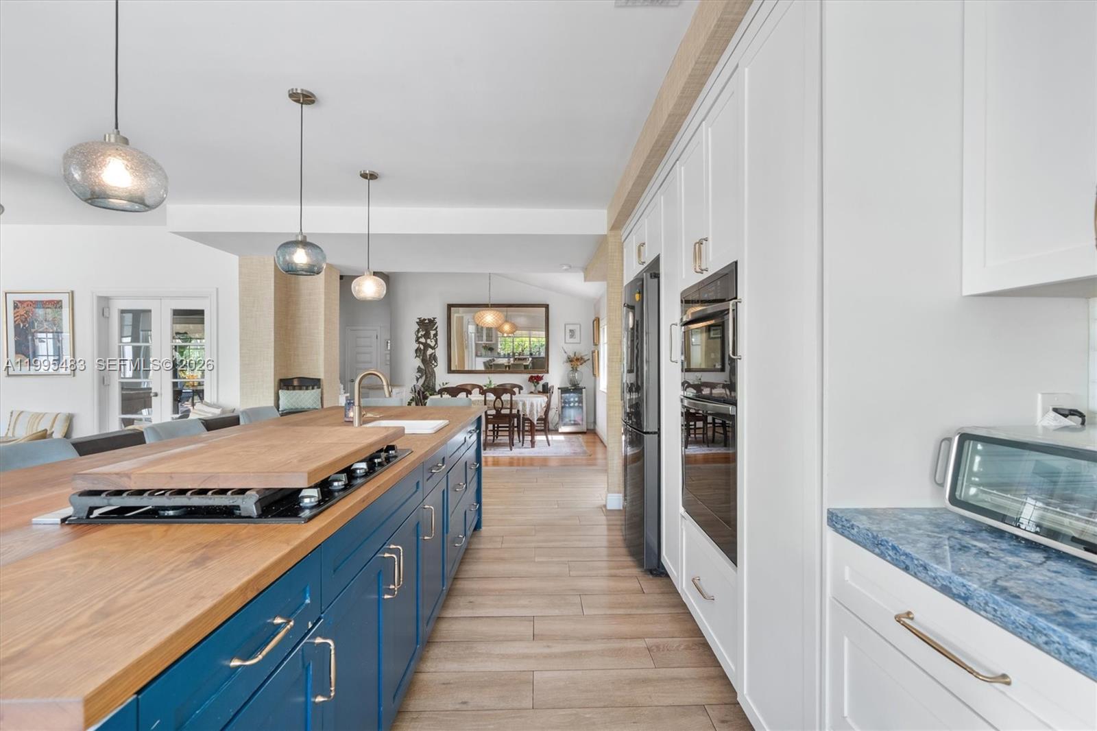 9636 Northeast 5th Avenue Road Miami Shores, FL 33138 - Photo 31 of 86 a large kitchen with kitchen island a large counter space a sink and stainless steel appliances
