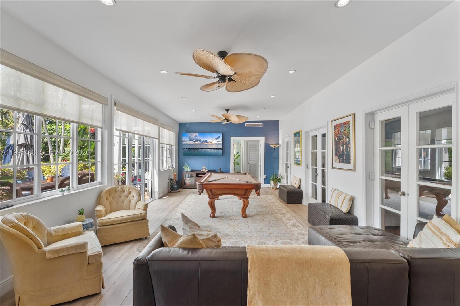 9636 Northeast 5th Avenue Road Miami Shores, FL 33138 - Photo 32 of 86 a living room with furniture fireplace and large windows