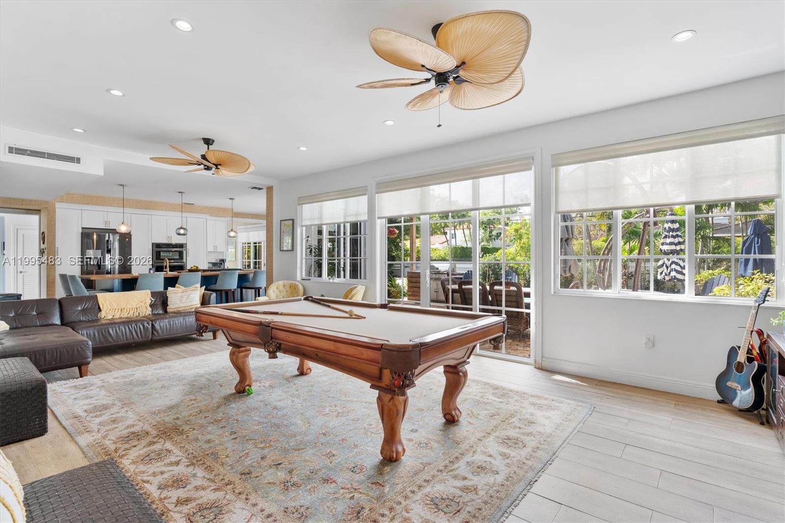 9636 Northeast 5th Avenue Road Miami Shores, FL 33138 - Photo 35 of 86 a living room with furniture a table and a large window